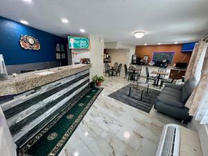 a lobby of a hotel with a bar and a restaurant at Key West Inn - Roanoke in Roanoke