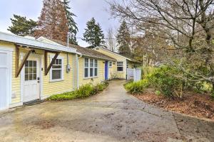 a yellow house with a white door and a driveway at Bainbridge Island Abode Less Than 1 Mi to Winslow! in Winslow