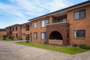 a large brick building with an open courtyard at Apollo Unit 20 Ground Floor in Narooma