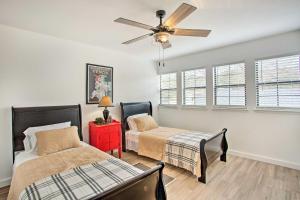 a bedroom with two beds and a ceiling fan at Lakefront Frankston Home with Guest Studio! in Coffee City