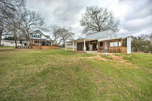 a house on a field with a large yard at Lakefront Frankston Home with Guest Studio! in Coffee City