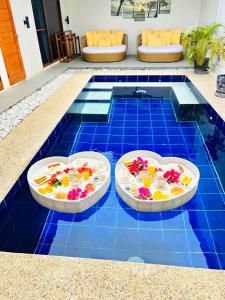 two plates of food on top of a pool at Bali Villas Panglao Bohol in Panglao