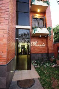 a building with a sign on the side of it at OKE Apart Hotel in San Lorenzo