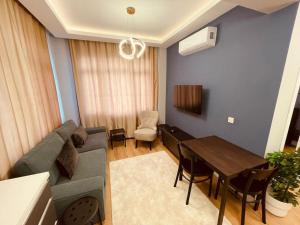 a living room with a couch and a table at Fully equipped apartment, Fatih in Istanbul