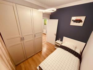 a small bedroom with a bed and a room with a door at Fully equipped apartment, Fatih in Istanbul