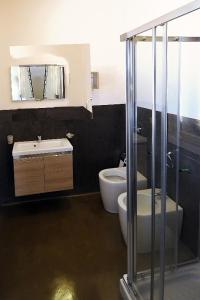 a bathroom with a toilet and a sink at Villa Elen in Marsala