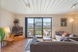 a living room with a couch and a tv at Apollo Unit 27 - Ground Floor - C Block in Narooma