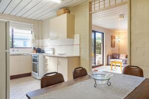 a kitchen and dining room with a table and chairs at Apollo Unit 27 - Ground Floor - C Block in Narooma