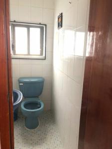 uma casa de banho com um WC azul e uma janela em Hermoso Departamento todas las comodidades WiFi em Tuxtla Gutiérrez