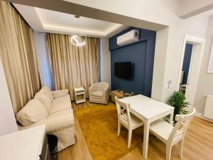 a living room with a white couch and a table at Private Apt, 2 mins to Transp. in Istanbul
