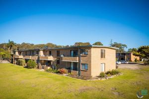 an exterior view of a house with a yard at Apollo Unit 30 First Floor in Narooma