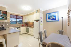 a kitchen with a table and a dining room at Apollo Unit 7 1st Floor in Narooma