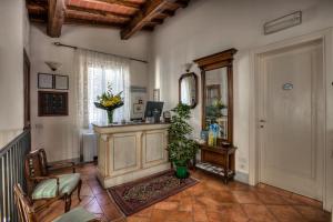 a living room with a desk and a mirror at Hotel Locanda Degli Artisti in Borgo San Lorenzo