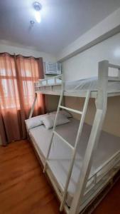 a white bunk bed in a room at Davao City Condo Living Made Easy Lifestyle in Davao City