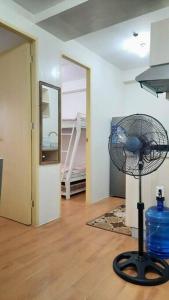 a room with a fan in the middle of a room at Davao City Condo Living Made Easy Lifestyle in Davao City