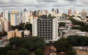 a tall building with a hotel center on top of it at Hotel Caiuá Cascavel in Cascavel