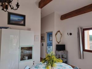 a living room with a bed and a television at coustelline in Le Lavandou