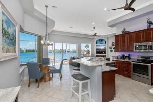 a kitchen with a view of the water at Waterfront home with pool, spa and 2nd floor balcony in Marco Island