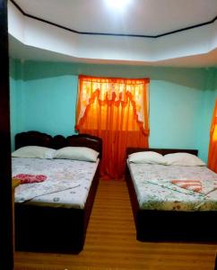 En eller flere senge i et værelse på OYO 931 Moreno's Place