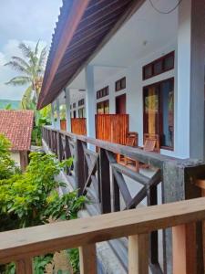 a balcony of a house with chairs on it at LilyPad guest house in Kuta Lombok