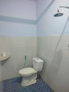 a bathroom with a white toilet in a room at LilyPad guest house in Kuta Lombok
