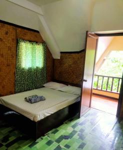 OYO 931 Moreno's Lodging Boracay في بوراكاي: سرير صغير في غرفة مع نافذة