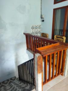 a wooden staircase in a room with chairs at LilyPad guest house in Kuta Lombok