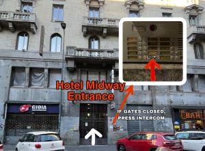 a picture of a hotel midway entrance with cars parked in front of a building at Hotel Midway in Milan