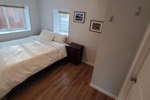 a small bedroom with a bed and a window at Luxury DT Cottage - Free Parking - Self Check-In in Anchorage