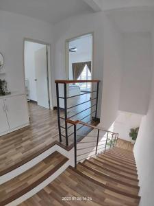 a staircase in a room with two mirrors and a stair case at Prima Guest House - Puncak Alam Homestay Mus-lim friendly in Bandar Puncak Alam