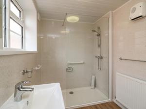 a bathroom with a shower and a sink at Cliff Farm No 2 Cottage in Burton Bradstock +15 photos