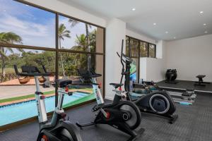 a gym with cardio machines and a swimming pool at San Lameer Villa 10425 - 1 Bedroom Classic - 2 pax - San Lameer Rental Agency in Southbroom