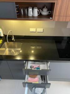 a kitchen with a sink and a counter top at Escape BestFamily Condo 1st Beach line in Ban Ang