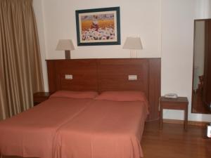 Postel nebo postele na pokoji v ubytování Hotel Mayna