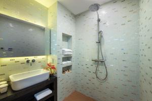 a bathroom with a sink and a shower at The Clouds Apartment in Shenzhen