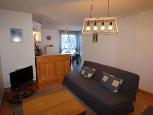 a living room with a couch and a tv at Appartement Bagnères-de-Luchon, 3 pièces, 6 personnes - FR-1-313-150 in Luchon