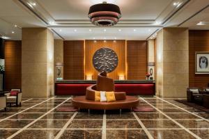 a lobby of a hotel with a sculpture in the middle at Grosvenor House, a Luxury Collection Hotel, Dubai in Dubai