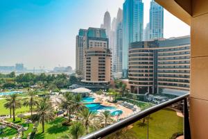 a view of a city from a balcony of a resort at Le Royal Meridien Beach Resort & Spa Dubai in Dubai