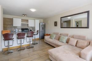 uma sala de estar com um sofá e uma cozinha em San Lameer Villa 10417 - 1 Bedroom Classic - 2 pax - San Lameer Rental Agency em Southbroom