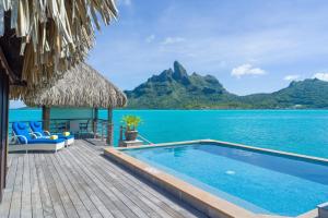 a resort with a swimming pool and a view of the ocean at The St. Regis Bora Bora Resort in Bora Bora