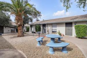 a patio with a table and chairs in front of a house at Cozy 1BR sleep 6+ Free Parking in Phoenix