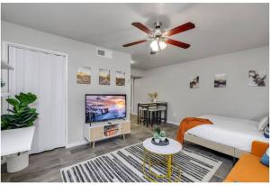 a living room with a bed and a ceiling fan at Cozy 1BR sleep 6+ Free Parking in Phoenix