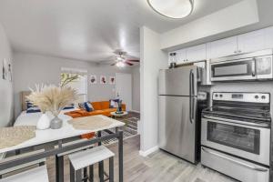 a kitchen and living room with a stainless steel refrigerator at Cozy 1BR sleep 6+ Free Parking in Phoenix