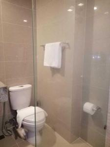 a bathroom with a toilet and a glass shower at Uptown Parksuites Apartments Tower 1 BGC by PH Staycation in Manila