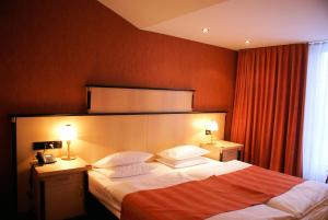 Postel nebo postele na pokoji v ubytování ARVENA Messe Hotel
