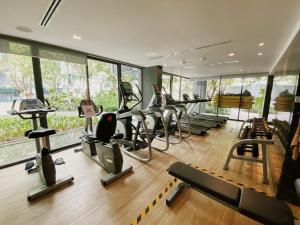 a gym with a bunch of treadms and cardio machines at The Deck Condo Studios Patong w/ pool fitness in Patong Beach