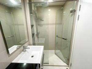 a bathroom with a sink and a shower at The Deck Condo Studios Patong w/ pool fitness in Patong Beach +15 photos