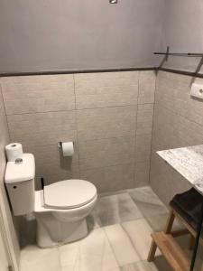 a bathroom with a white toilet and a sink at Apartamentos Makao Puerta del Olivillo in Jerez de la Frontera +49 photos