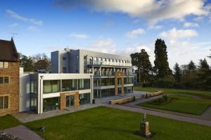 a large building with a lawn in front of it at Ashorne Hill Leamington Spa in Leamington Spa