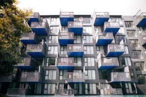 a building with blue balconies on the side of it at The Deck Condo Studios Patong w/ pool fitness in Patong Beach